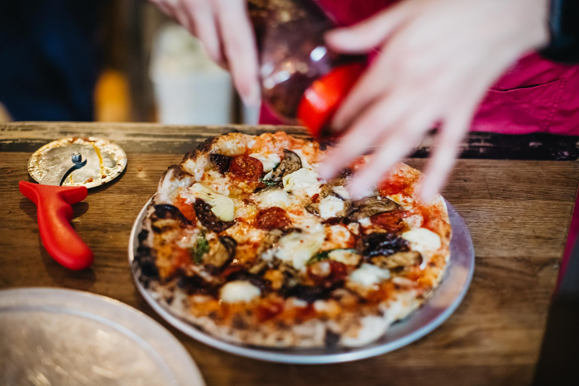 Slicing a handmade Italian pizza